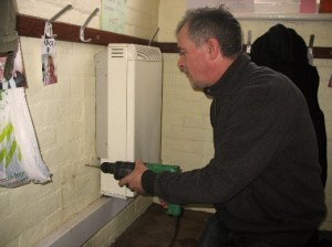 Aiano engineer Steve while heater guard installation process AIANO senior engineer Steve installing one of the bespoke radiator guards.