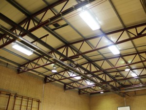 AIANO wire mesh guards in school sports hall AIANO bespoke light guards in school sports hall